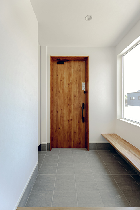 窓とベンチのある明るい玄関ホール